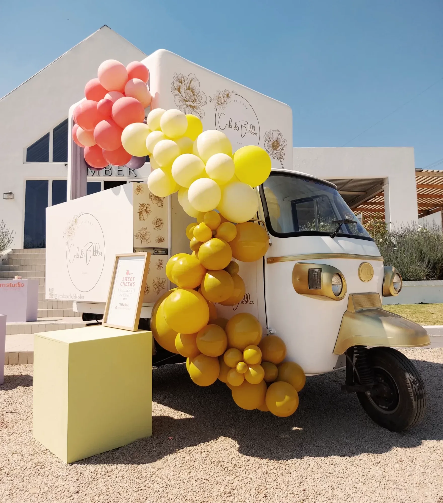 Mobile bar with yellow and pink balloon decorations
