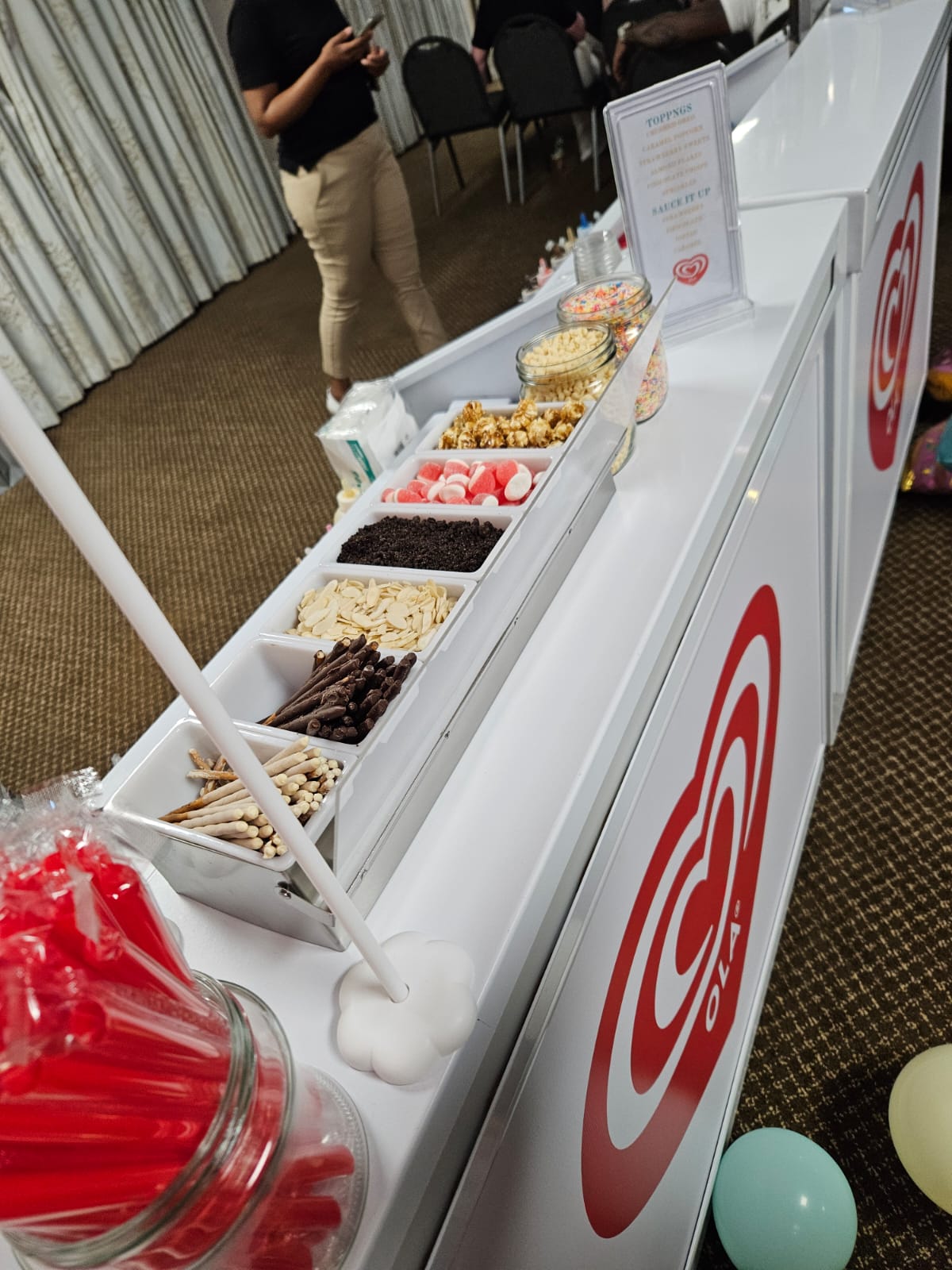 Dessert station with candy, snacks, and colorful containers
