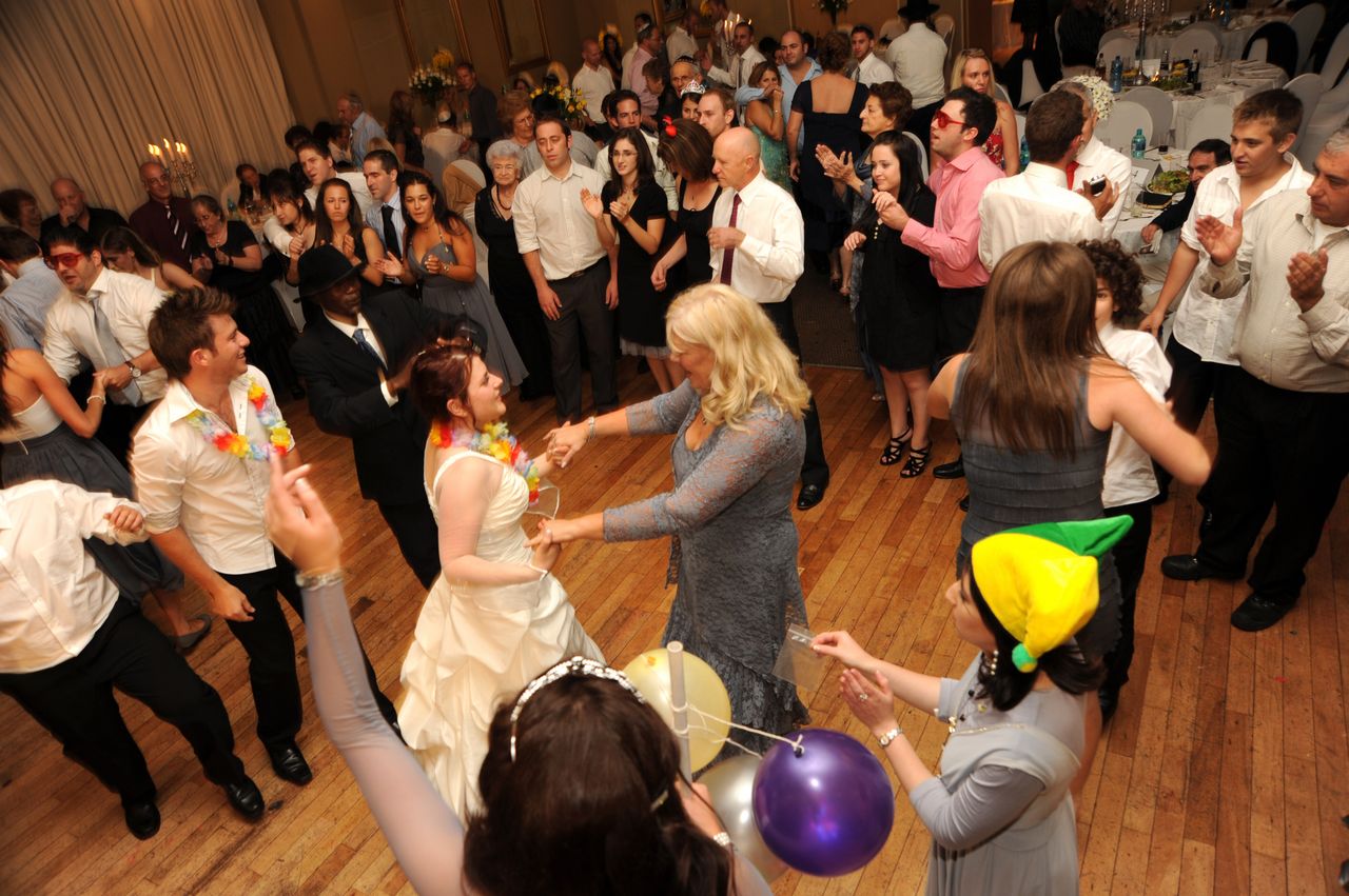 A lively dance floor filled with guests enjoying a celebration.
