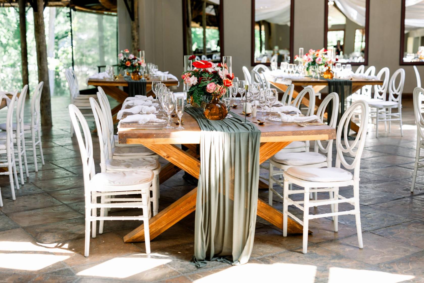 Elegant table setup with floral arrangements and fabric drapery
