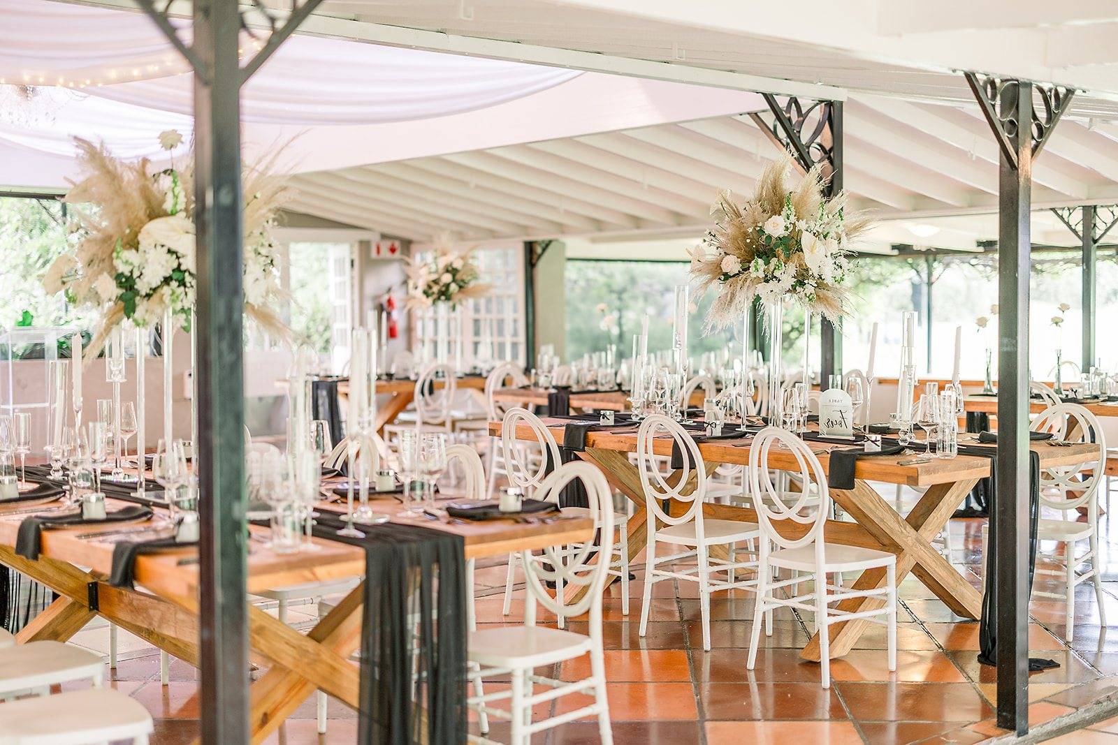 Elegant wedding table setup with floral arrangements and decor.