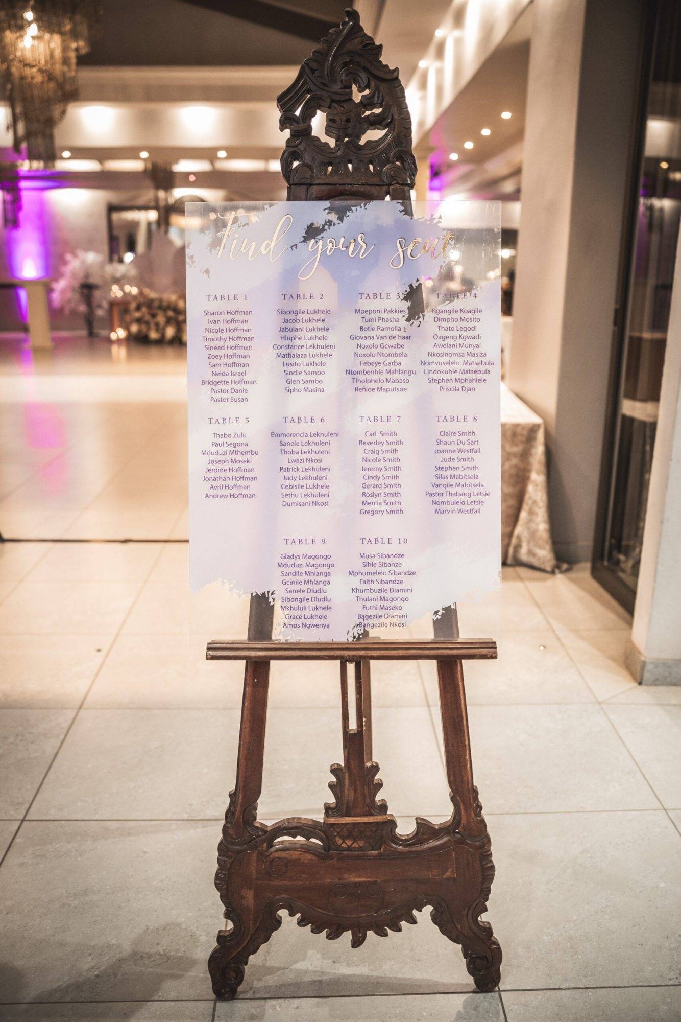 Decorative wooden easel displaying a seating plan
