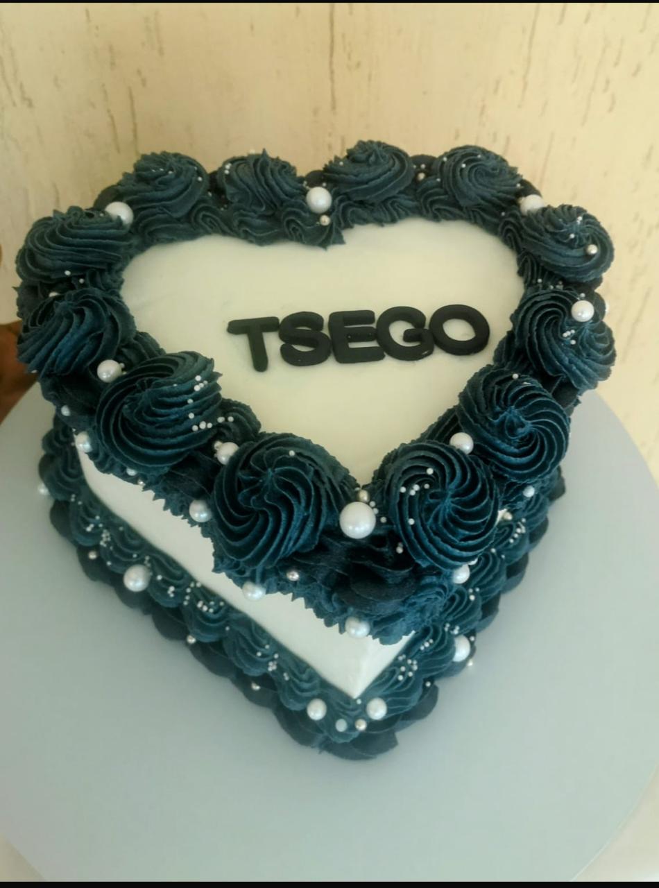 Heart-shaped cake with teal frosting and name TSEGO