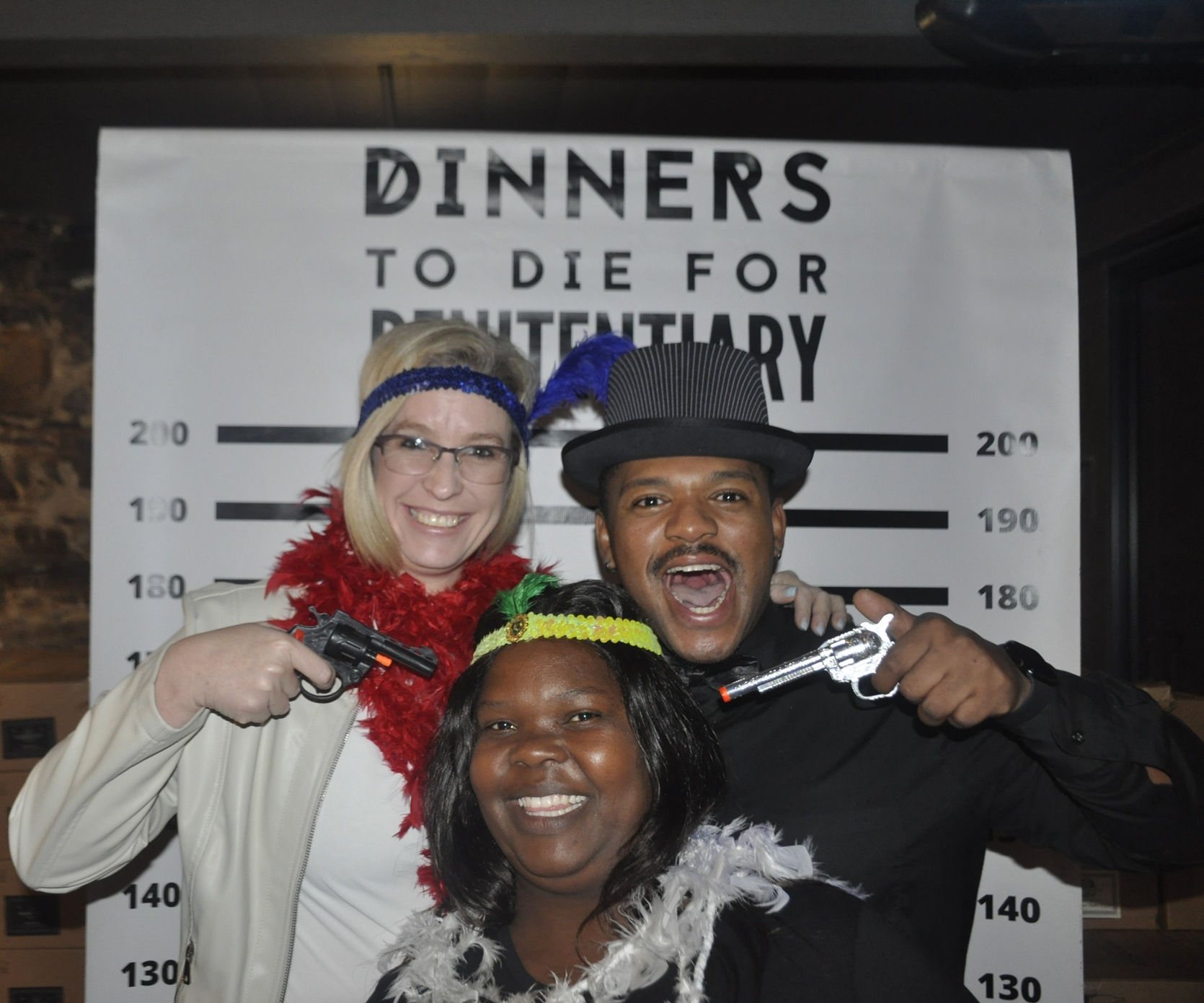 Actors dressed for a murder mystery event with props