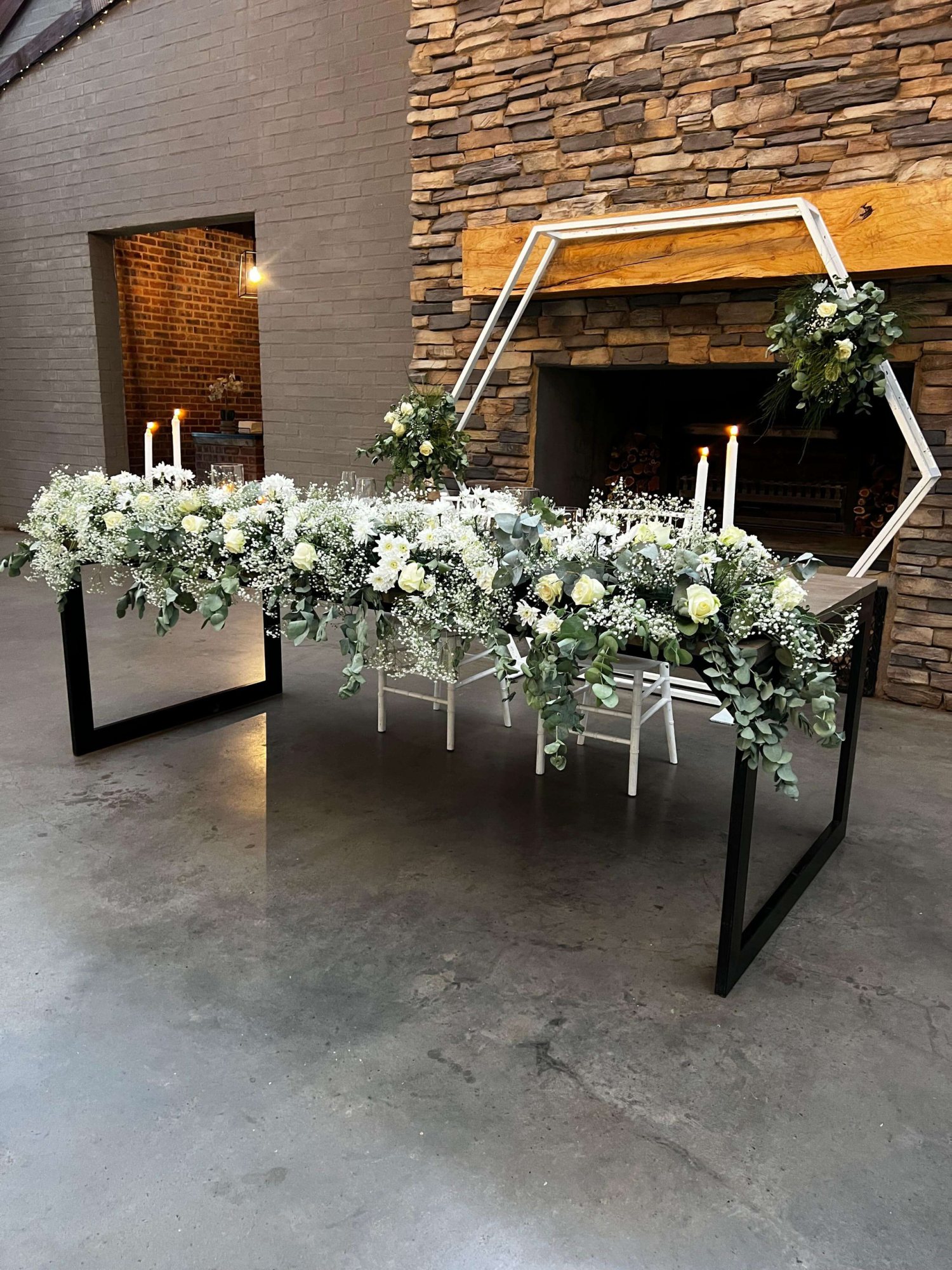 Floral centerpiece setup on a table with candles