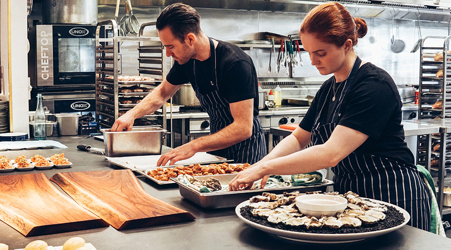 Event team preparing donuts in a kitchen