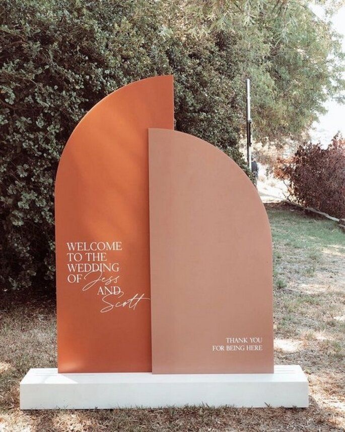 A two-tone wedding welcome sign with personalized names.
