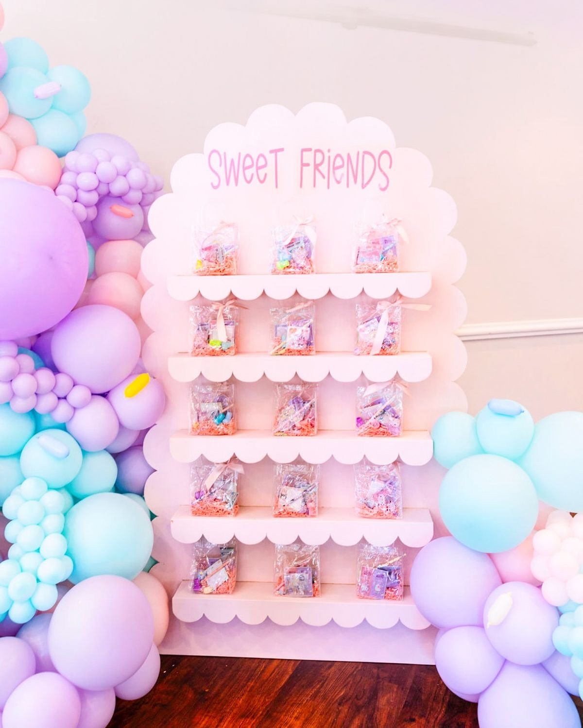 Colorful candy display with pastel balloons decor