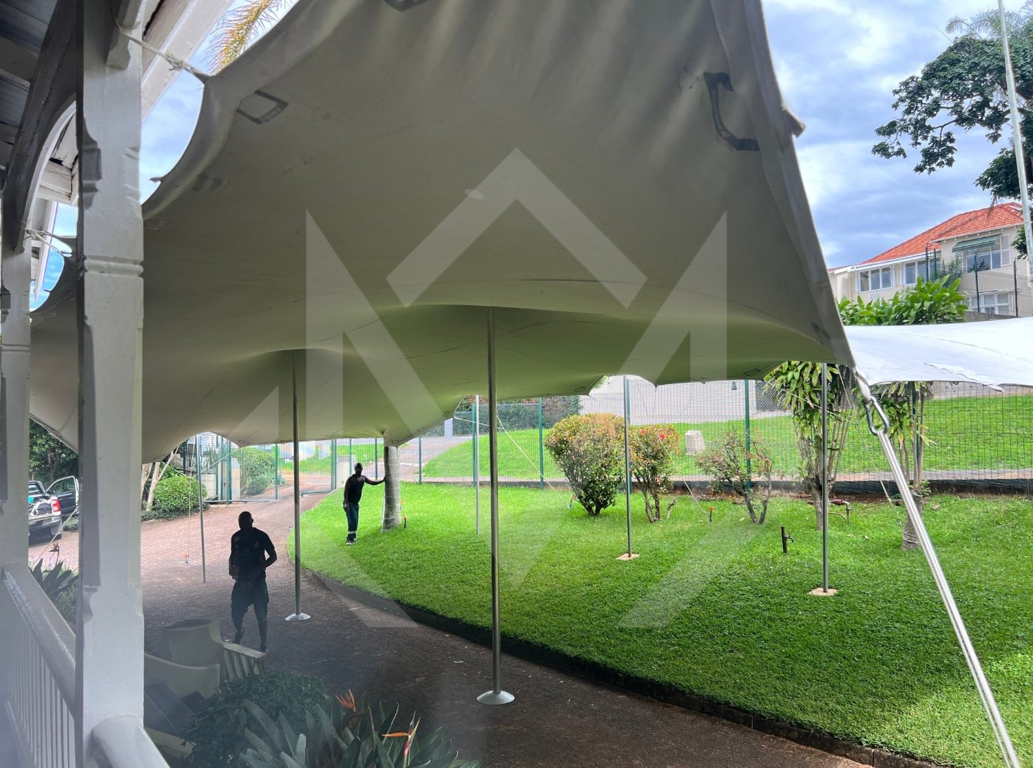 Outdoor stretch tent setup with supports