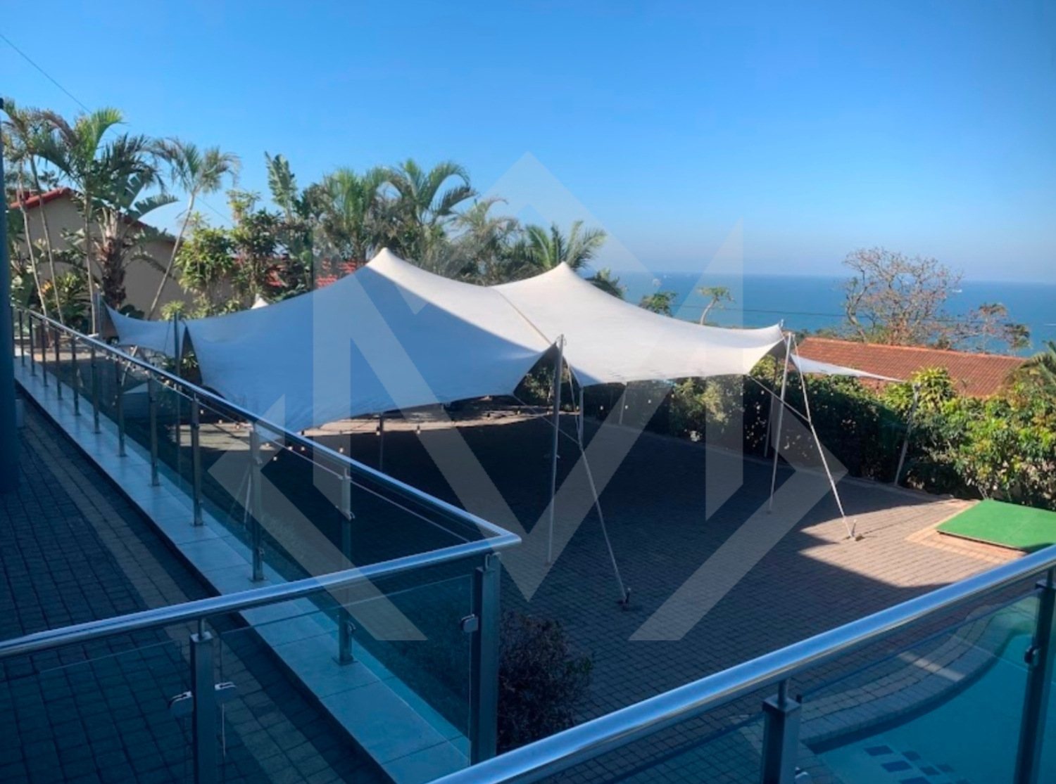 White stretch tent in an outdoor setting with ocean view