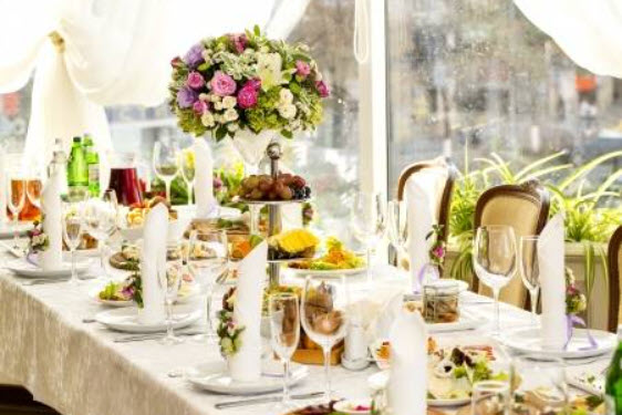 Elegant table setting with floral centerpiece and assorted dishes.