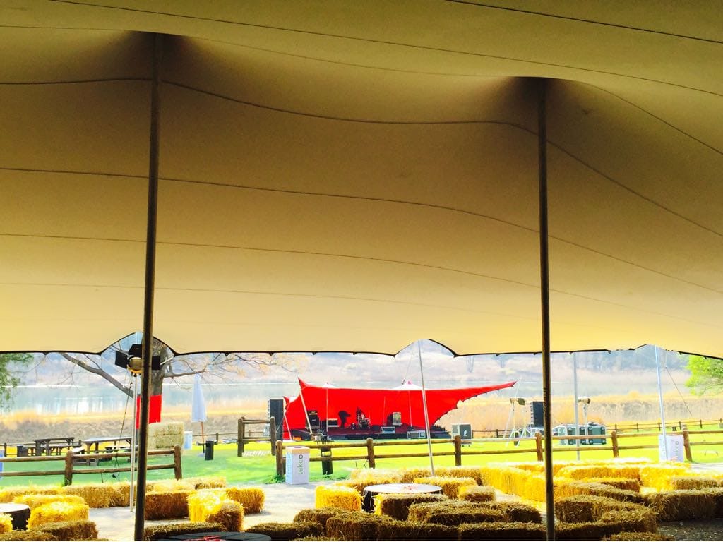 Interior view of a spacious stretch tent setup with a stage.