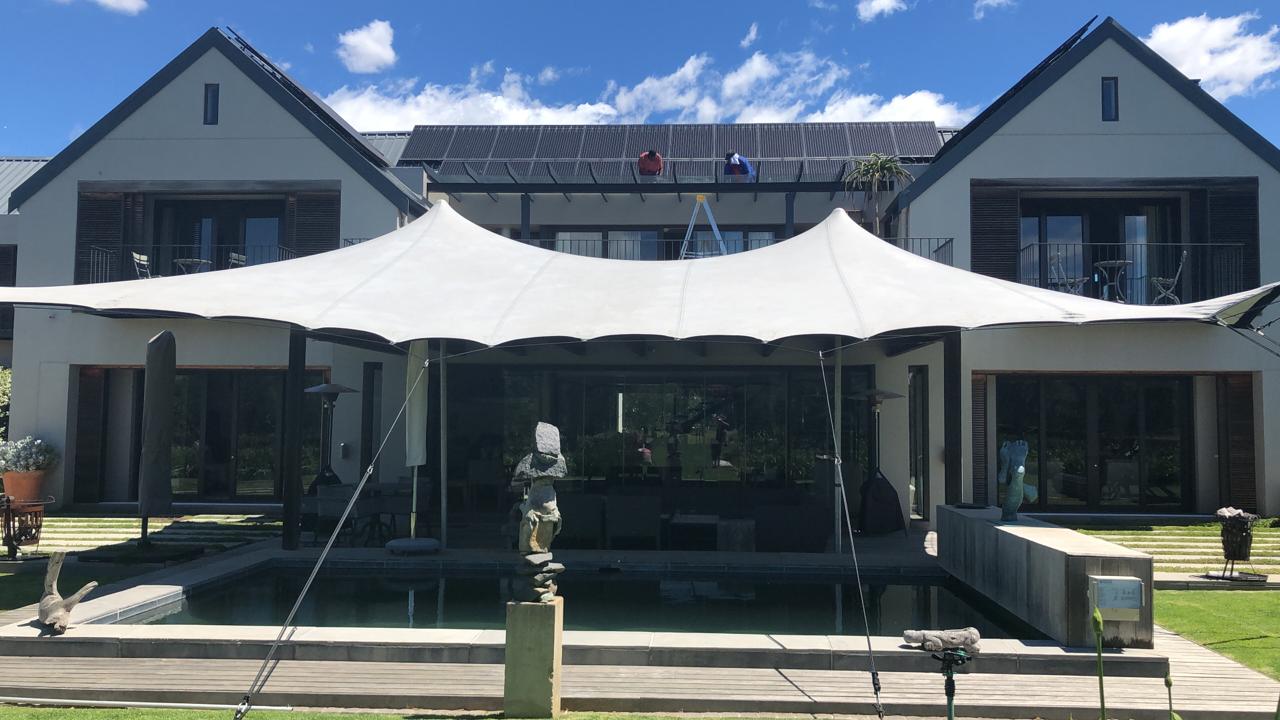 Large outdoor event canopy in front of a modern building