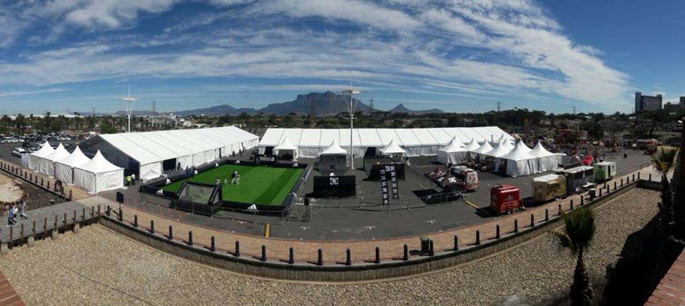 Large outdoor event venue with tents and activities