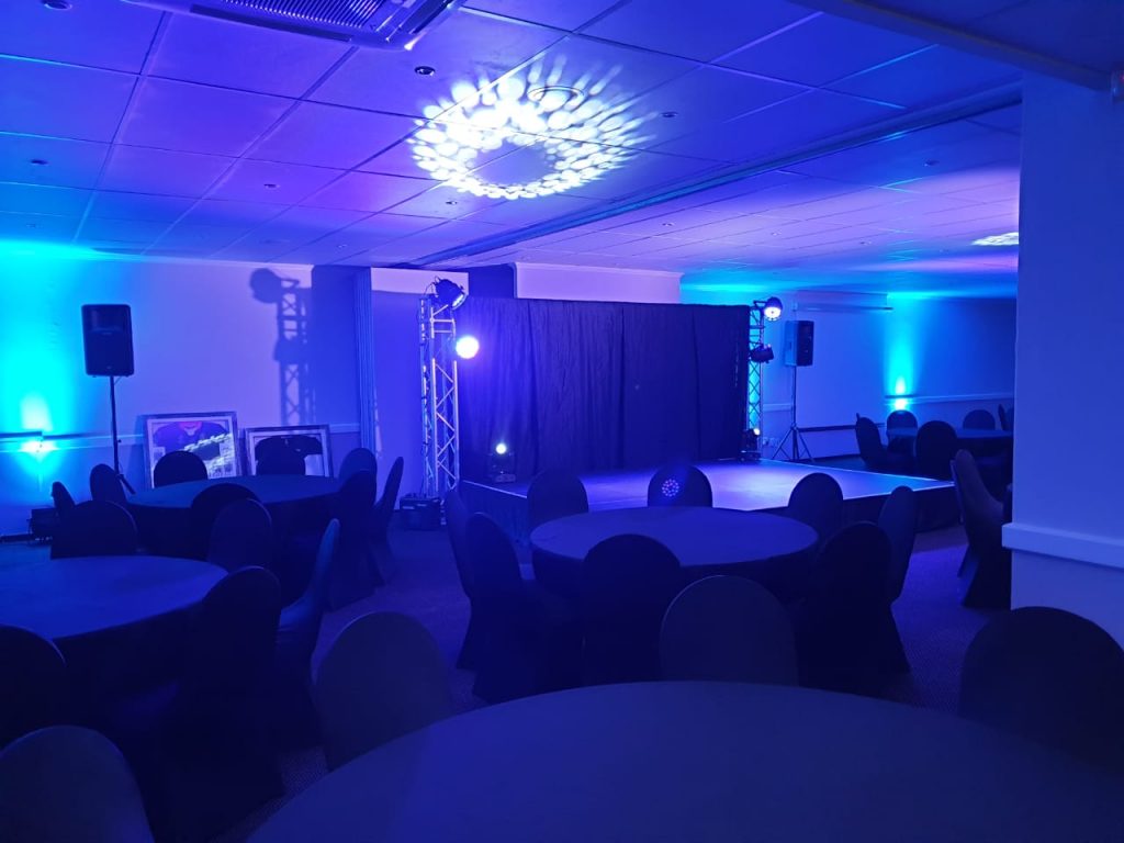 Event setup featuring round tables and ambient lighting
