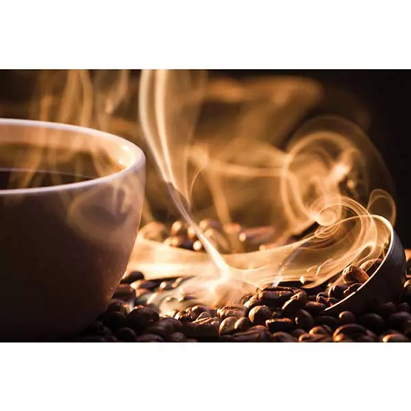 A steaming cup of coffee surrounded by coffee beans.