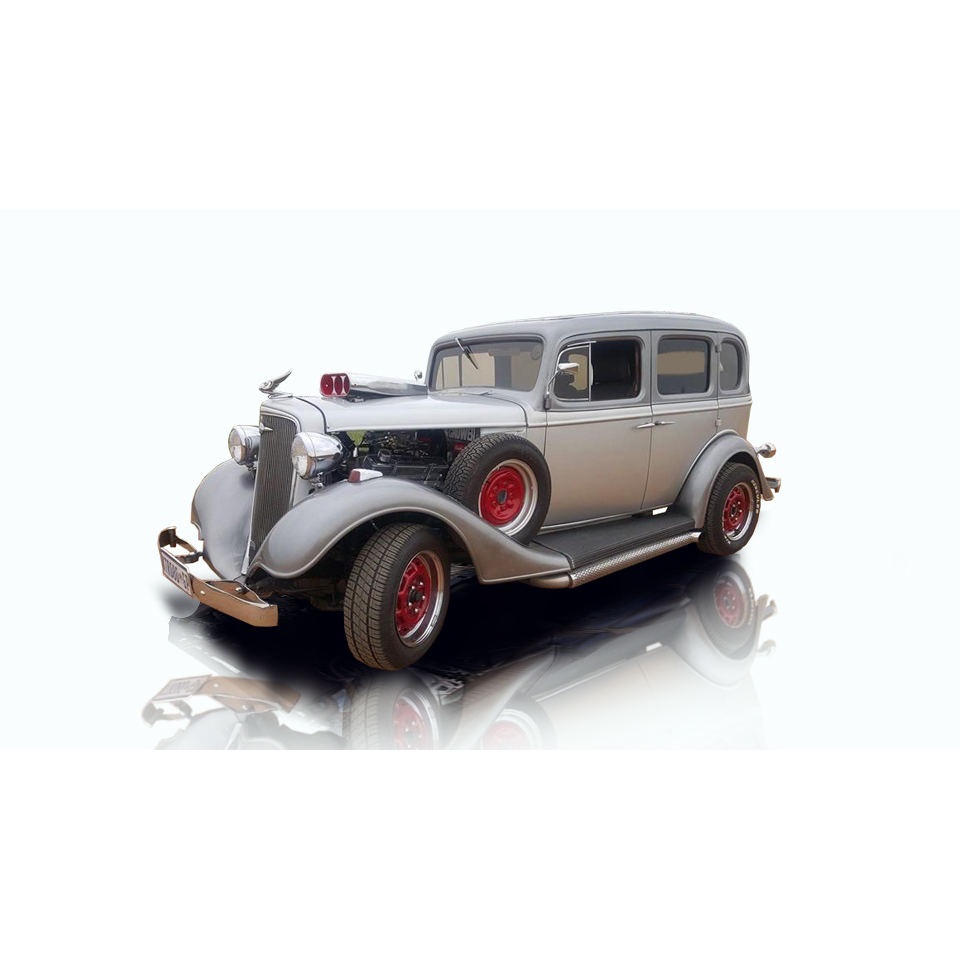 Restored vintage car with red wheels and a silver body