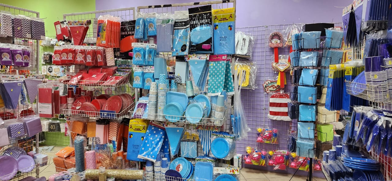 Colorful display of party supplies on shelving