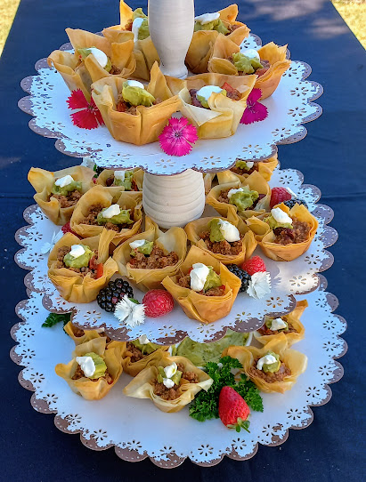 Tiered serving platter with pastry cups filled with various toppings.