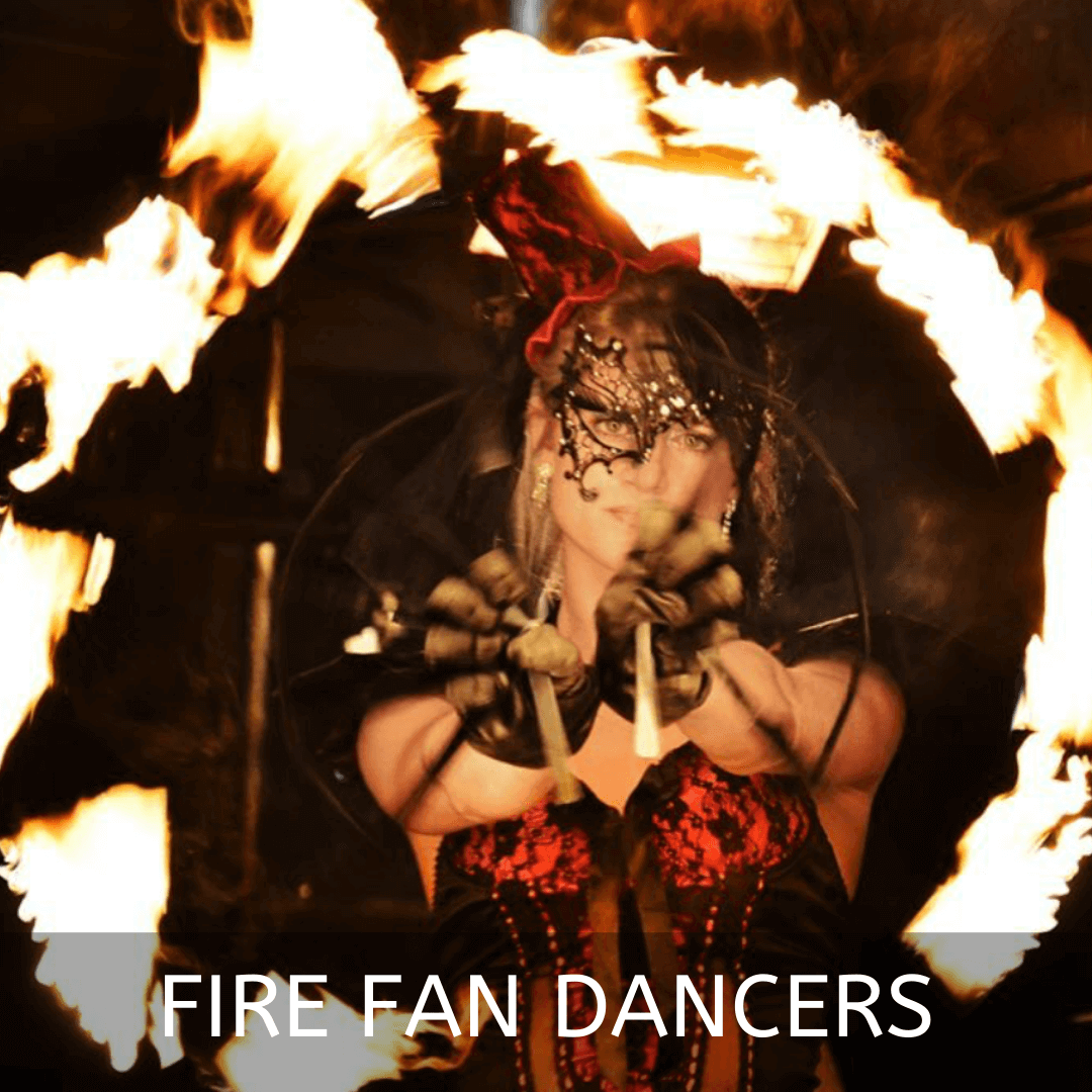 Performer showcasing fire fans in a dramatic performance