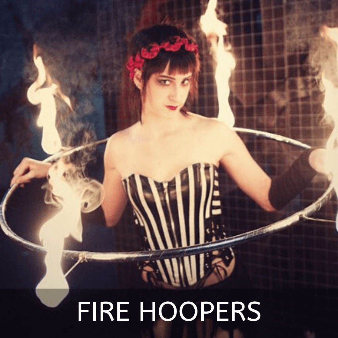 Fire performer using fiery hoops