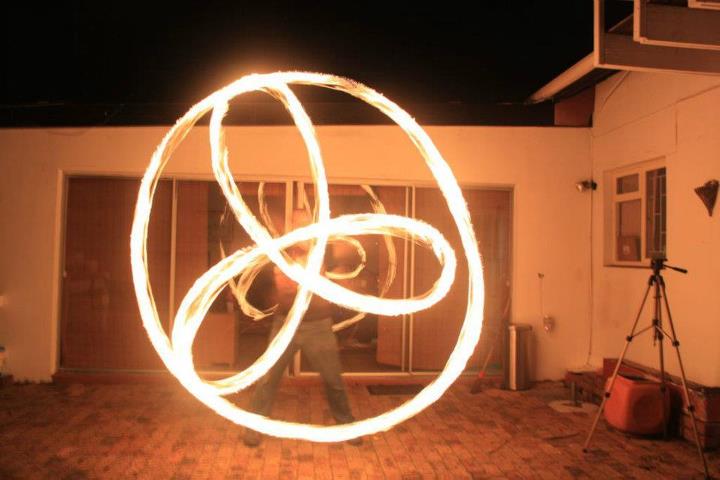 Fire poi dancer creating intricate flame patterns