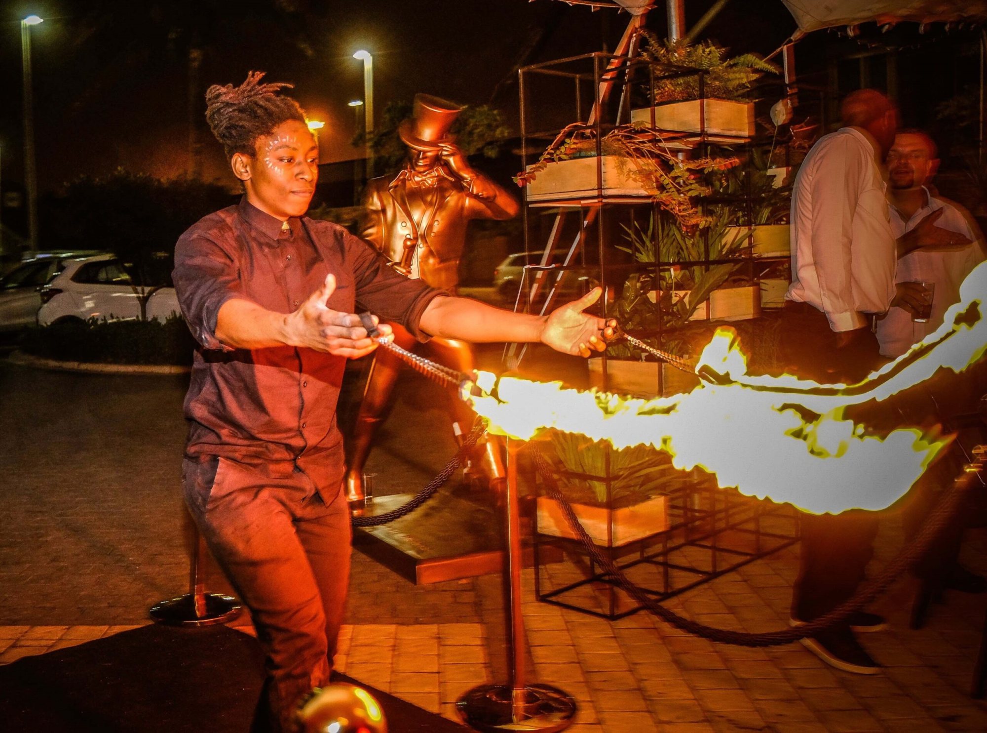 LED performer demonstrating fire flow arts at an event.