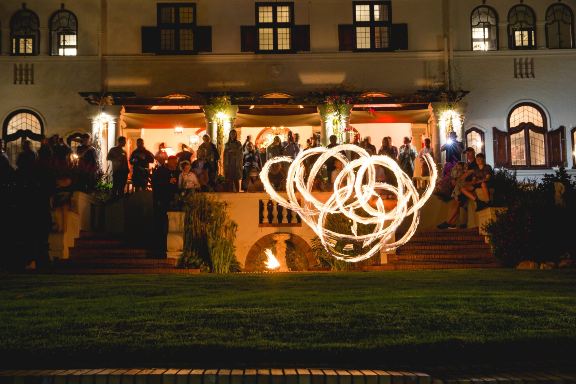 FireTribe performers captivating an audience with fire dancing