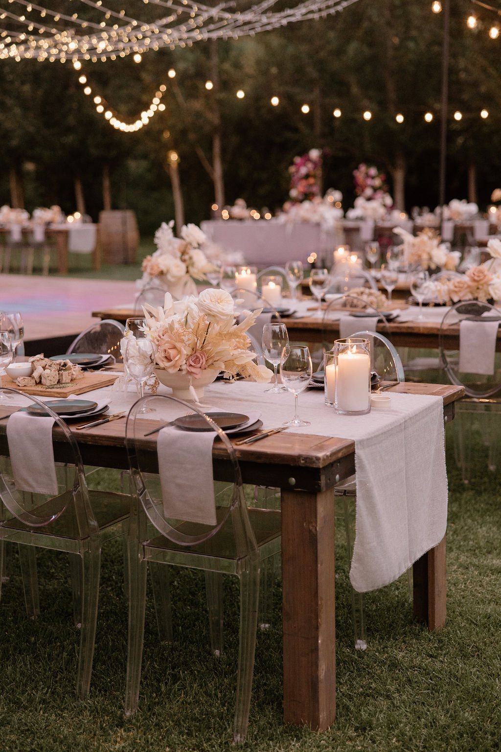 Outdoor dining table with floral arrangements and candles