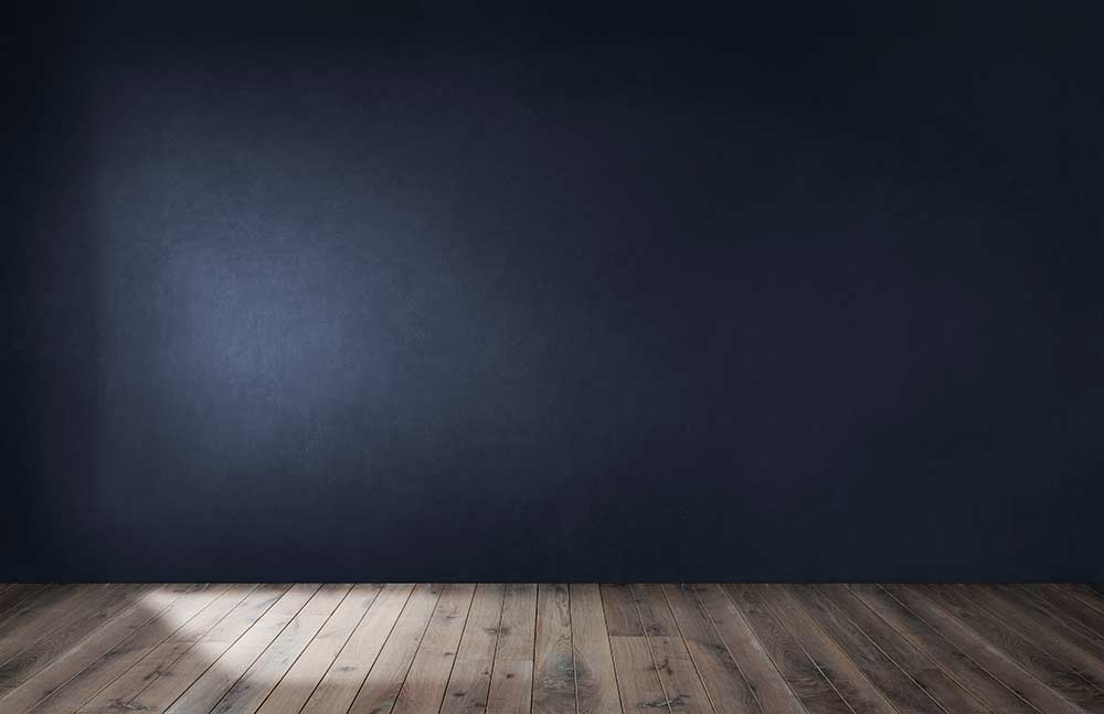 Plain dark wall and wooden floor setup