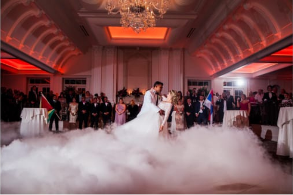 Couple dancing on a cloud during their wedding reception