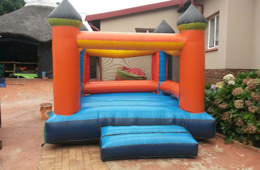 Brightly coloured inflatable jumping castle with steps.
