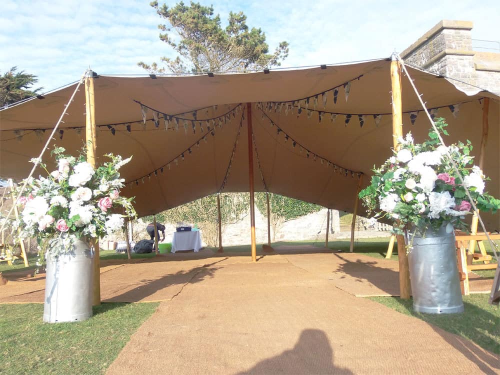 Stretch tent with floral arrangements at the entrance