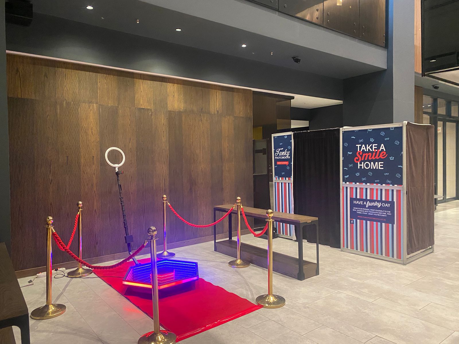 Photo booth setup with red carpet and ring light