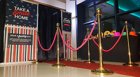Funky photo booth setup with red carpet and props