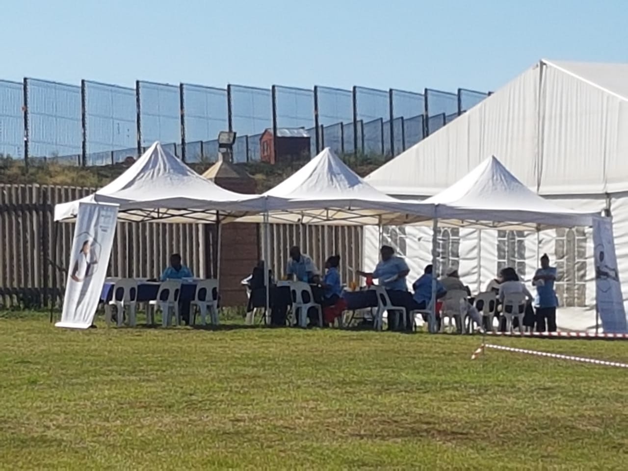 Setup of multiple gazebos with chairs for an event
