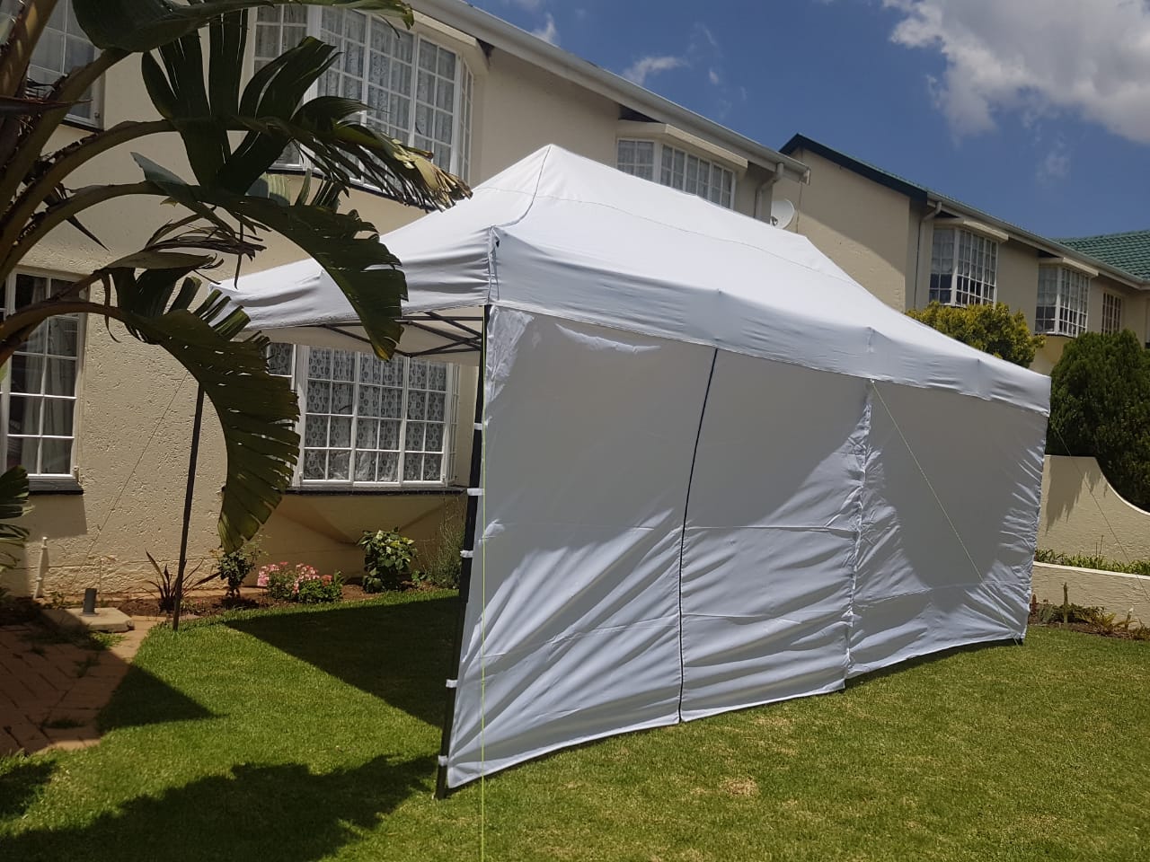 White outdoor gazebo setup in a garden