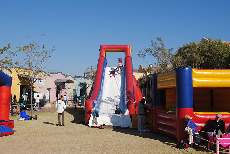 Colorful water slide with children sliding on a sunny day