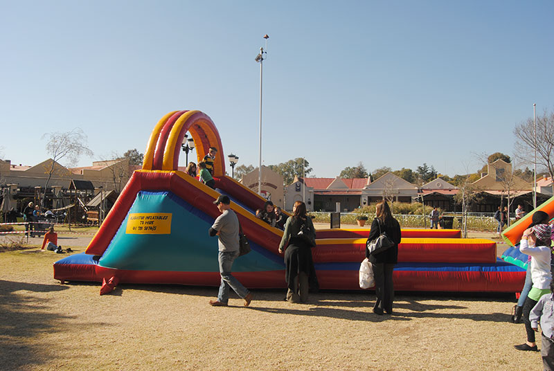 Colorful large inflatable slide in a grassy area