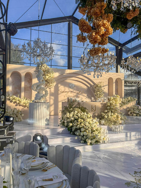Luxurious floral installation with white roses and elegant decor.