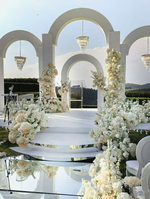 Floral wedding setup with arches and chandeliers