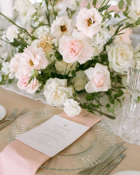 Beautiful floral centerpiece with pink roses and delicate white flowers.