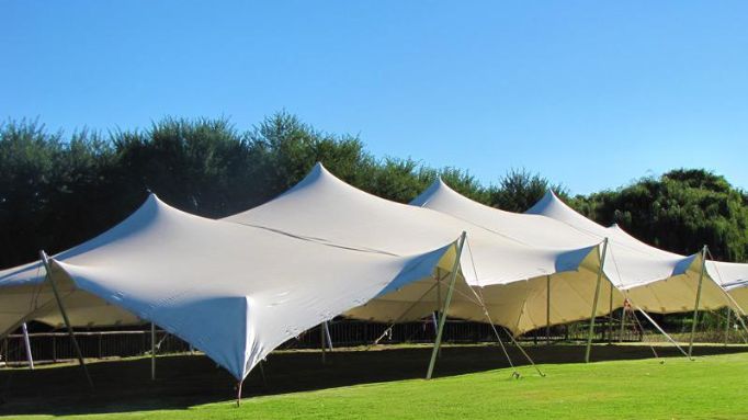 Large stretch tent set up on green grass