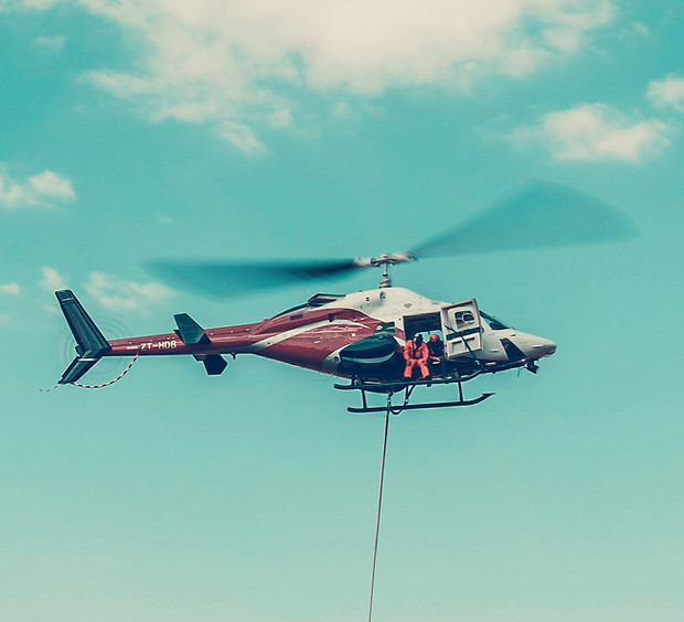 Helicopter in flight over Johannesburg against a blue sky.