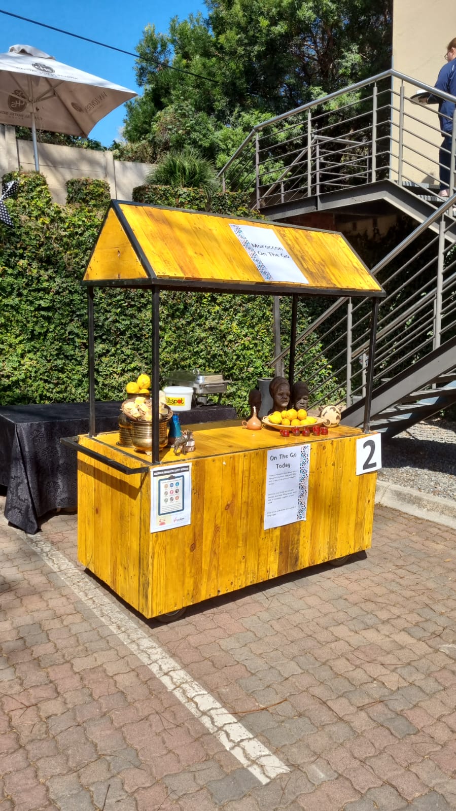 Bright yellow refreshment cart set up for events