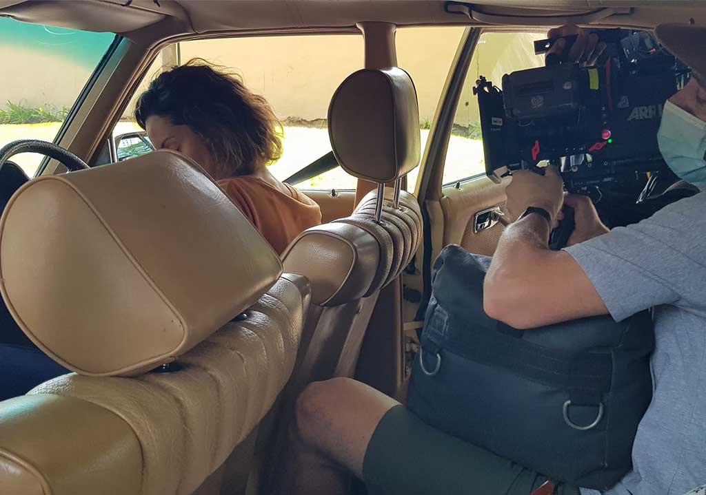 Interior of a vintage car during a film shoot.