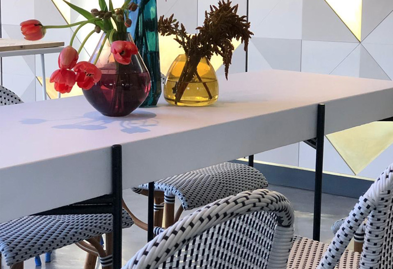 A modern table setup with vases and flowers in a stylish arrangement.