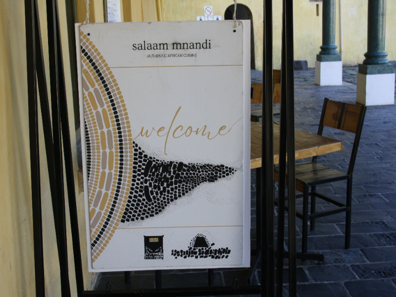 Welcome sign for Salaam Mnandi showcasing African cuisine