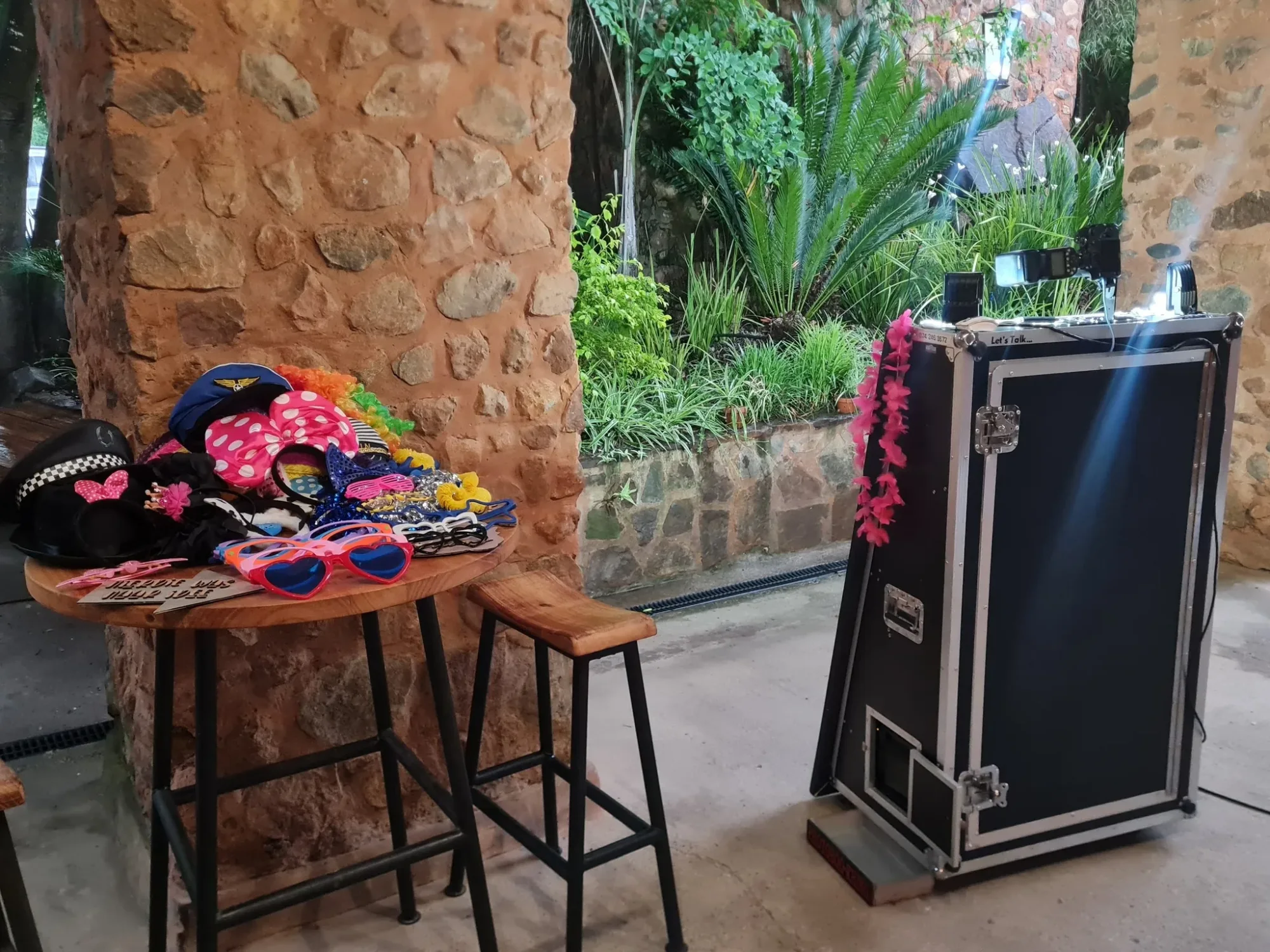 A table with various party props and a booth setup
