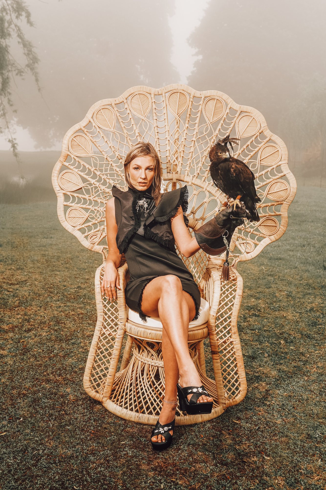 Woman sitting on a Peacock Pose Emperor Chair.